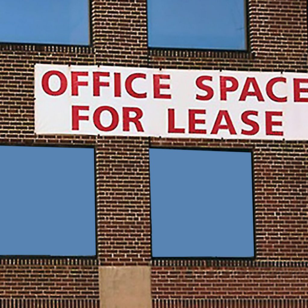 Vacant Office Space sits behind a For Lease sign